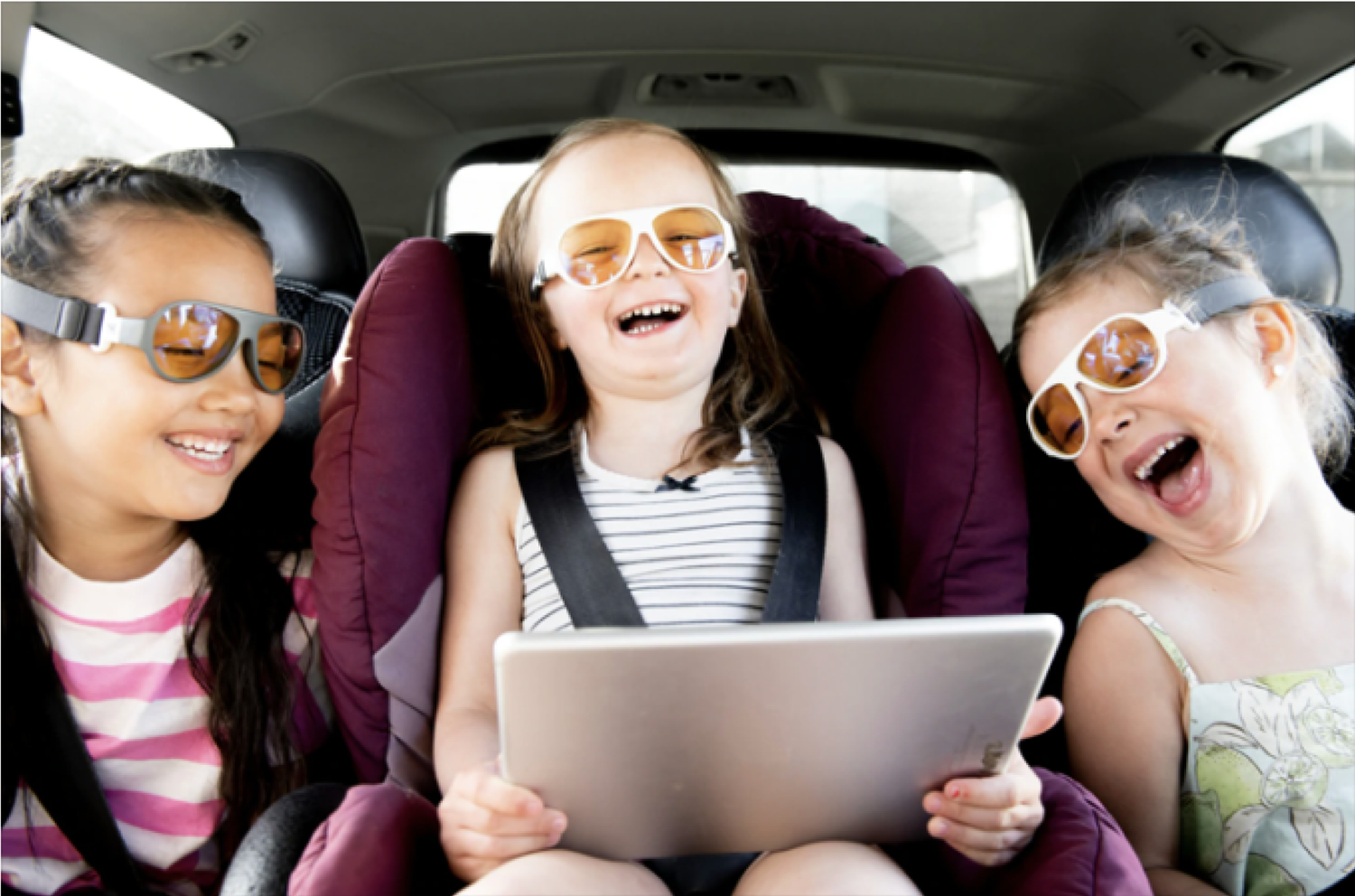 Girls wearing ScreenSafe glasses while looking at an iPad